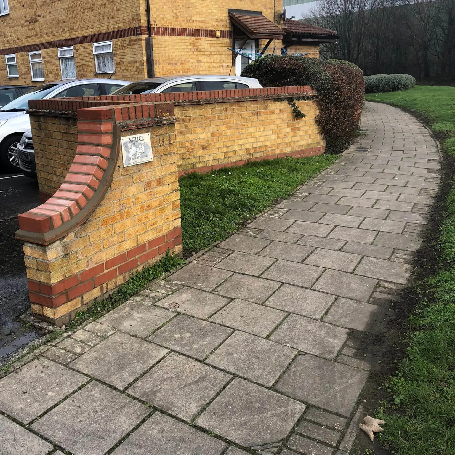 a brick wall with a sign on the side of it
